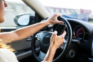 Teenage driver using cell phone while driving